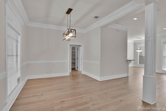 unfurnished dining area with baseboards, crown molding, light wood-style floors, and decorative columns