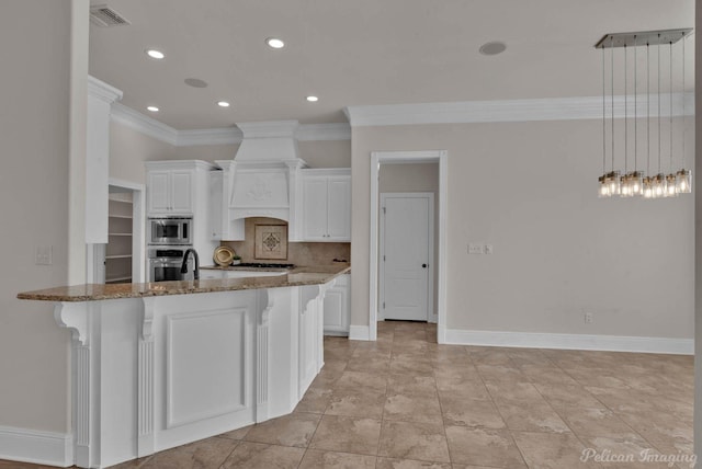 143 Eagle Bend Way, Shreveport, LA 71115 - kitchen with appliances with stainless steel finishes, crown molding, dark stone counters, white cabinets, and a kitchen bar