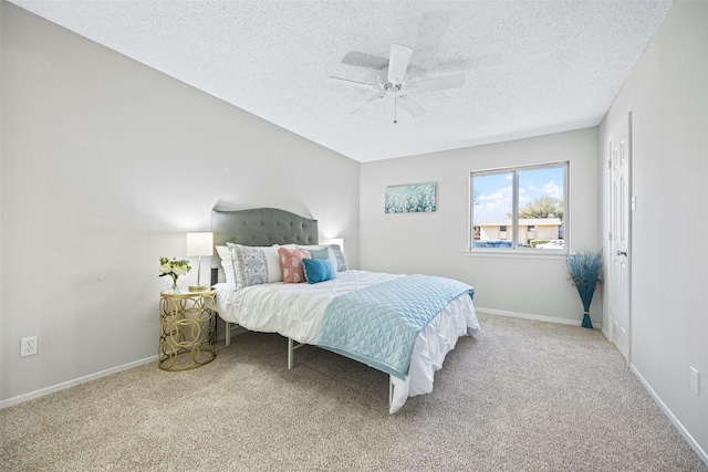 5831 Harvest Hill Rd Unit 1069, Dallas, TX 75230 - bedroom with carpet, a textured ceiling, baseboards, and a ceiling fan