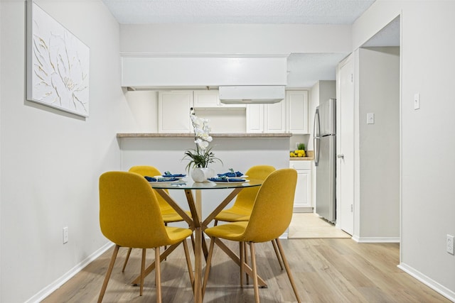 5831 Harvest Hill Rd Unit 1069, Dallas, TX 75230 - dining space with light wood-style flooring and baseboards