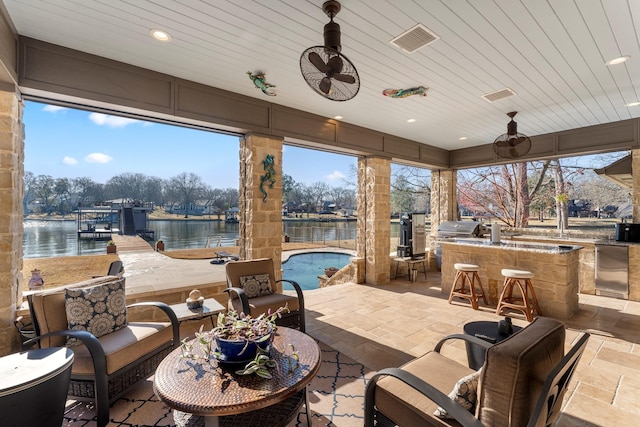 view of patio featuring visible vents, a grill, a water view, and area for grilling