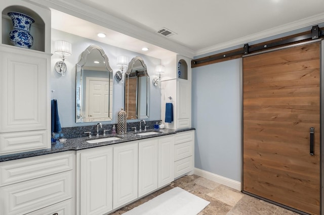 full bath featuring crown molding, double vanity, visible vents, and a sink