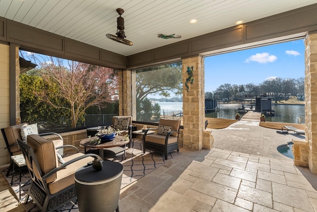 view of patio / terrace with outdoor lounge area and a water view