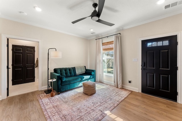 interior space with visible vents, wood finished floors, and ornamental molding