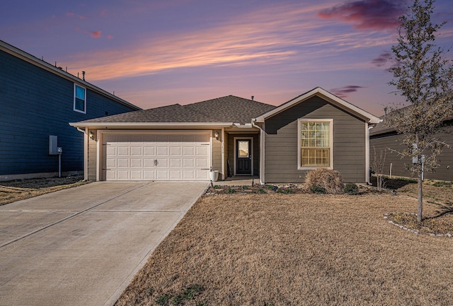 ranch-style house featuring roof with shingles, concrete driveway, and an attached garage