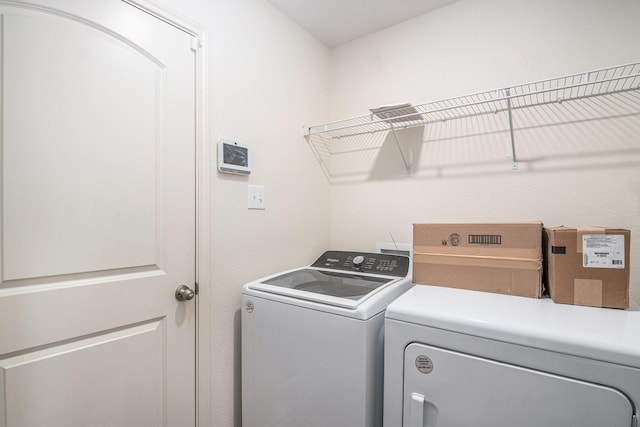 washroom featuring washing machine and dryer and laundry area