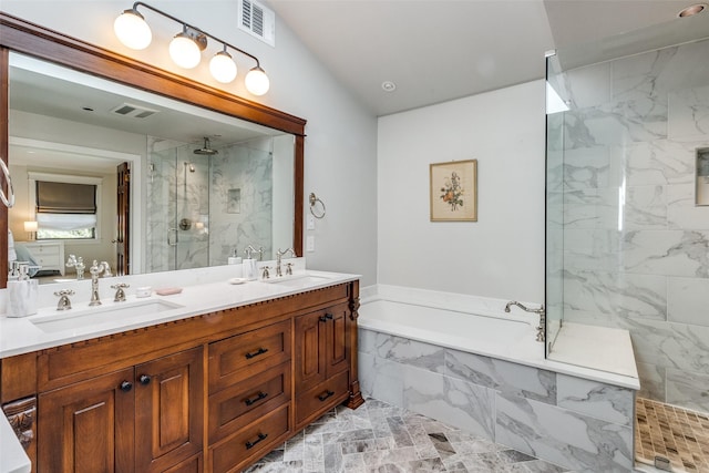 bathroom with a marble finish shower, visible vents, a bath, and a sink