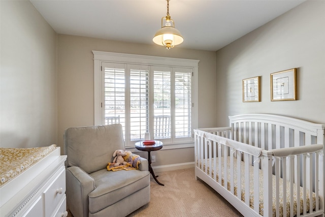 bedroom featuring baseboards and light carpet