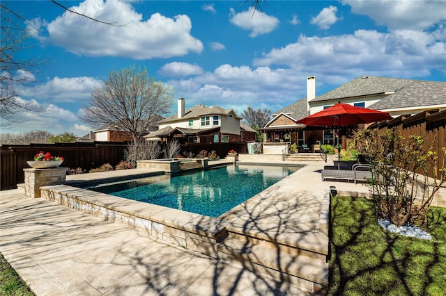 view of swimming pool featuring a fenced backyard, a fenced in pool, an in ground hot tub, and a patio