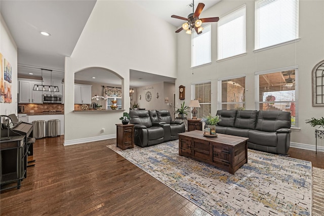 living area featuring ceiling fan, baseboards, dark wood finished floors, and recessed lighting