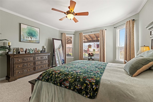 carpeted bedroom with a ceiling fan and ornamental molding