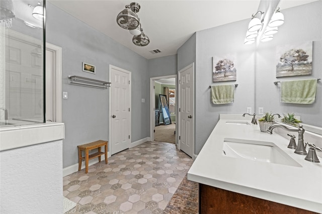 full bathroom featuring a sink, visible vents, walk in shower, and double vanity