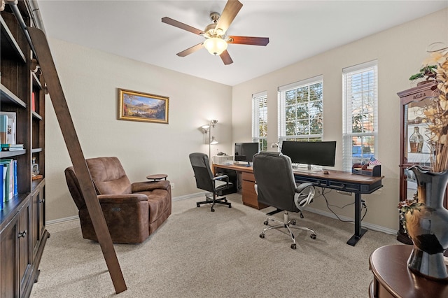 office area with light colored carpet, baseboards, and ceiling fan