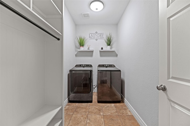 laundry area featuring washer and dryer, visible vents, baseboards, and laundry area