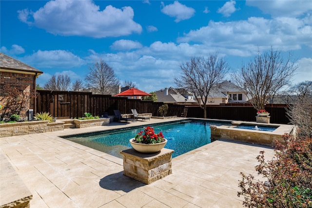 view of pool featuring a patio, a fenced in pool, an in ground hot tub, and a fenced backyard