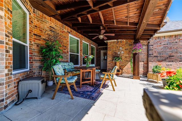 view of patio with outdoor dining space and ceiling fan