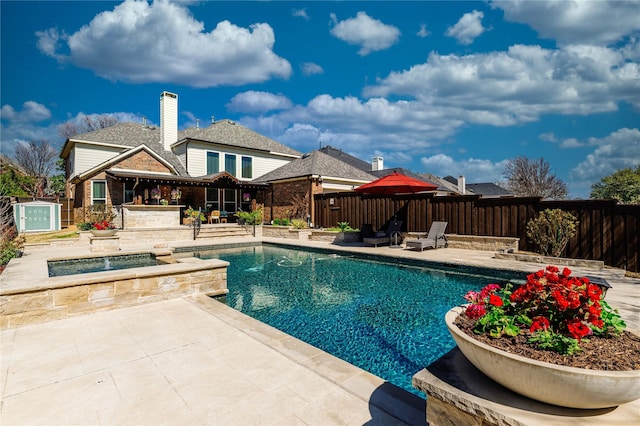 view of swimming pool with a patio area, a fenced in pool, an in ground hot tub, and a fenced backyard