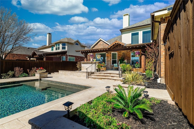 view of pool featuring a patio, a fenced backyard, and a fenced in pool