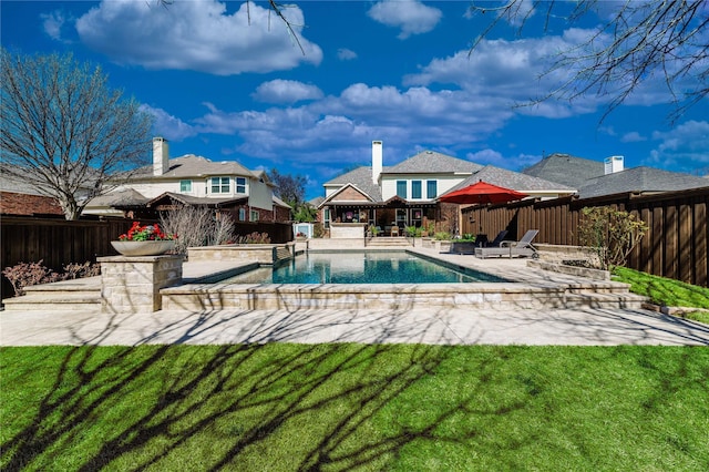 view of swimming pool featuring a yard, a patio, a fenced in pool, and a fenced backyard