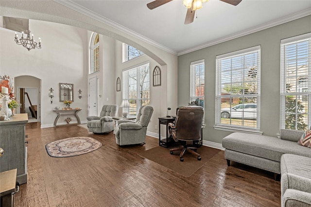 office featuring arched walkways, a healthy amount of sunlight, and wood finished floors