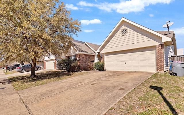 single story home with concrete driveway and brick siding