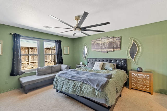 bedroom with visible vents, a ceiling fan, carpet flooring, and a textured ceiling