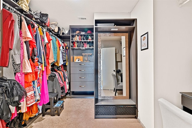 walk in closet featuring visible vents and carpet floors