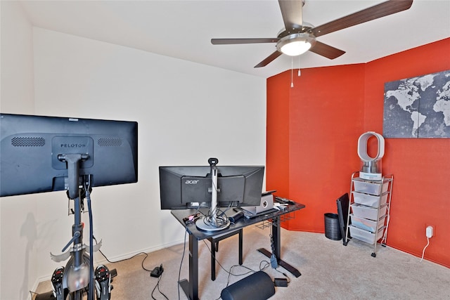 carpeted home office with baseboards and ceiling fan