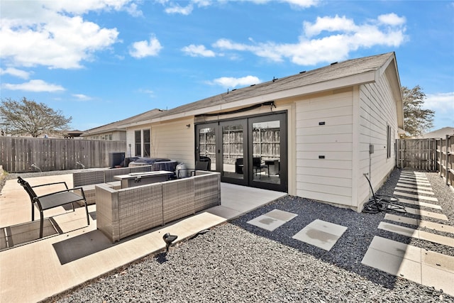 rear view of house with outdoor lounge area, a patio, and a fenced backyard