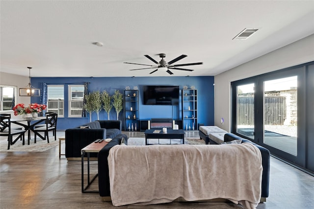 living room featuring visible vents and wood finished floors