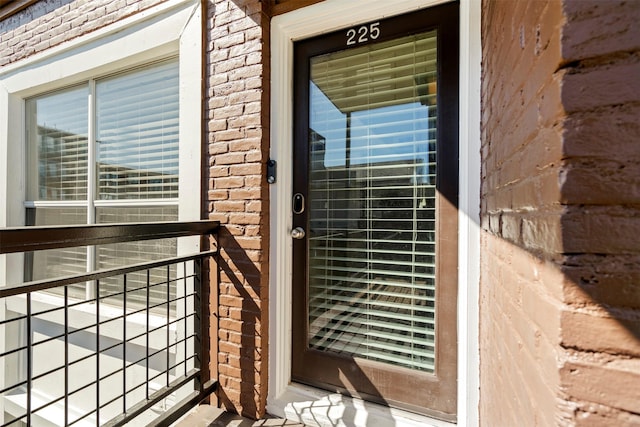 property entrance featuring brick siding