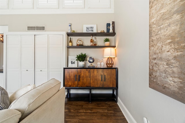 sitting room featuring visible vents, baseboards, and dark wood-type flooring