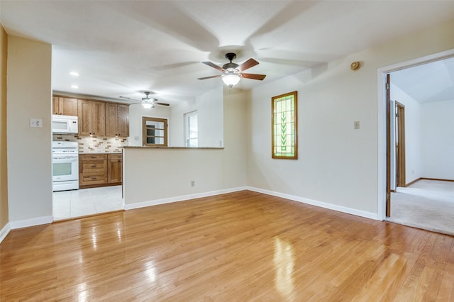 unfurnished living room with recessed lighting, baseboards, ceiling fan, and light wood finished floors