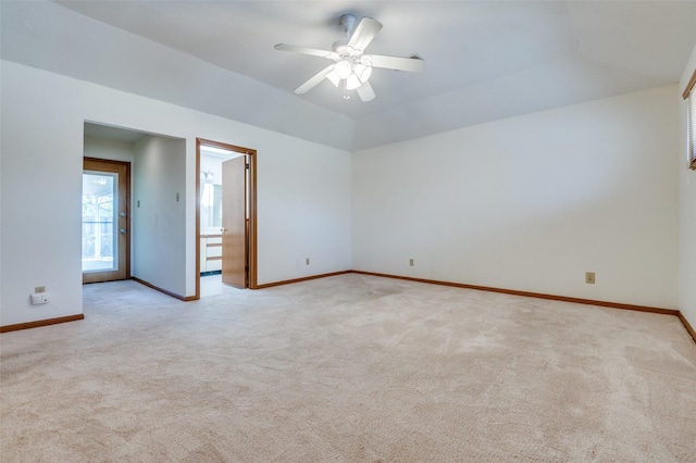 carpeted empty room with baseboards and a ceiling fan