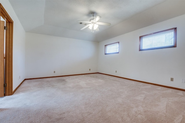 unfurnished room featuring light carpet, visible vents, ceiling fan, and baseboards