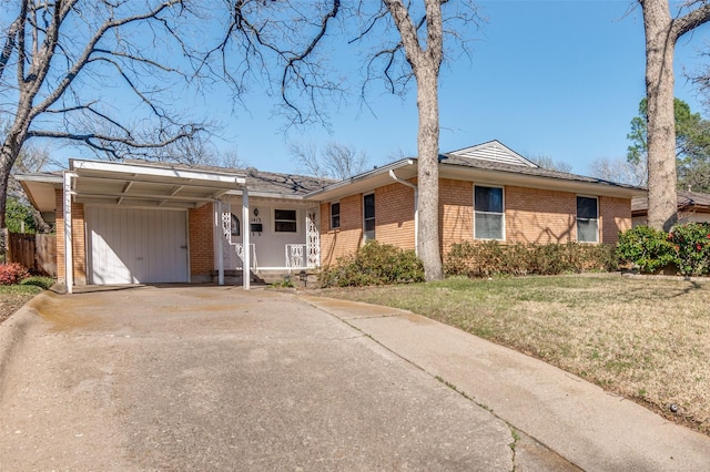 ranch-style home with a garage, a front yard, brick siding, and driveway