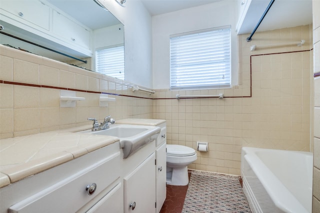 bathroom featuring tile patterned floors, toilet, tile walls, and vanity