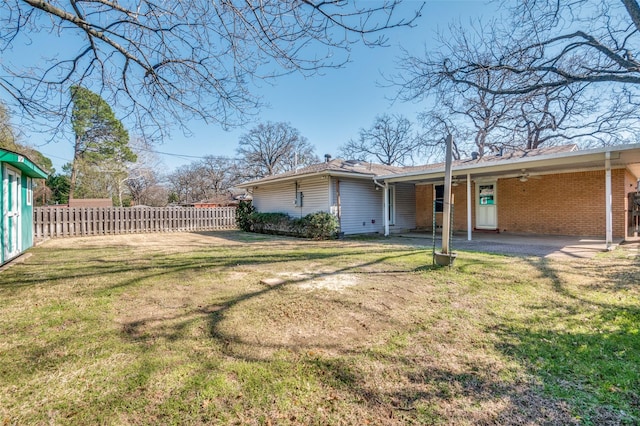 view of yard featuring a carport and fence