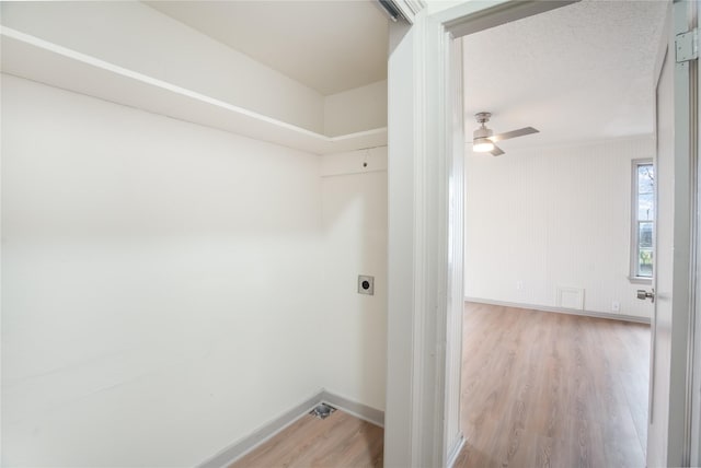 laundry area with baseboards, laundry area, wood finished floors, electric dryer hookup, and a ceiling fan