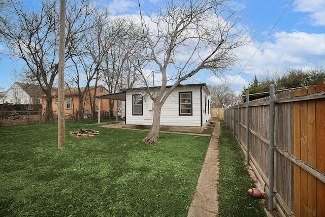 exterior space with a lawn and a fenced backyard