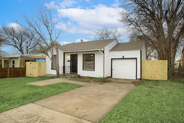 view of front of house with a front yard, a gate, fence, concrete driveway, and a garage