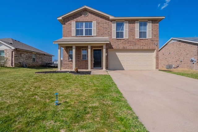 traditional-style house with a front yard, concrete driveway, an attached garage, brick siding, and central AC
