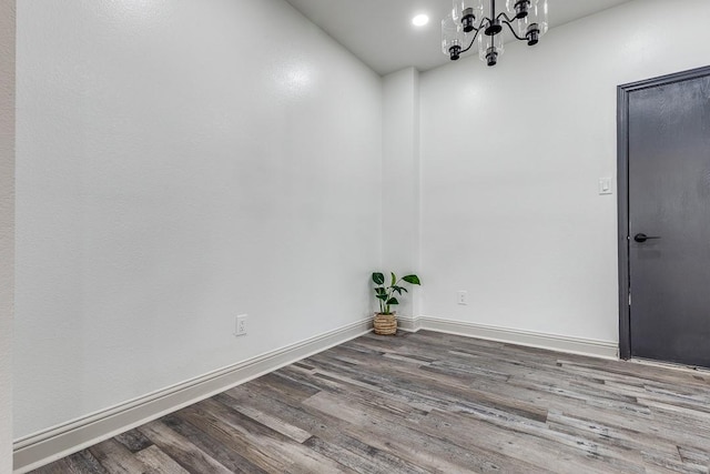 559 Helena St, Dallas, TX 75217 - unfurnished room featuring wood finished floors, a chandelier, baseboards, and recessed lighting