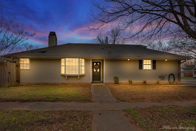 ranch-style house featuring a chimney