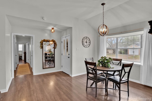 dining area featuring dark wood-style floors, a notable chandelier, and a healthy amount of sunlight