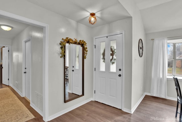 entryway featuring visible vents, wood finished floors, and baseboards