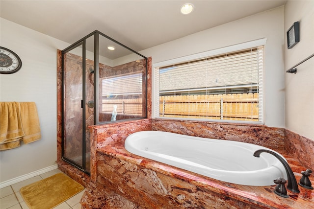 bathroom featuring baseboards, recessed lighting, tile patterned flooring, a shower stall, and a garden tub