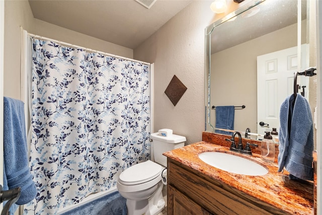 bathroom with toilet, vanity, a shower with curtain, and a textured wall