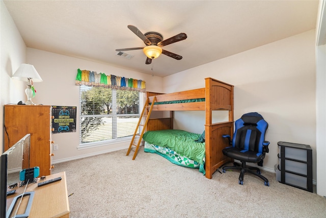 carpeted bedroom featuring baseboards, visible vents, and ceiling fan