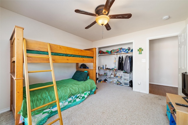 carpeted bedroom featuring a closet, baseboards, and ceiling fan